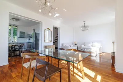 a living room with white furniture and a flat screen tv at Wide 1 Bdr Quiet Area Open View in Nice