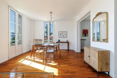 a staircase in a home with wooden floors and white walls at Wide 1 Bdr Quiet Area Open View in Nice