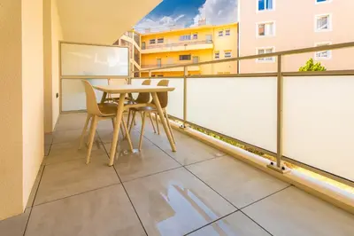 a balcony with a table and chairs in a building at Le Bô Mont in Nice