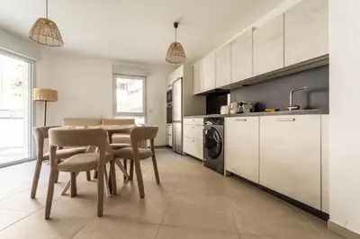 a kitchen with a table and chairs in a room at Le Bô Mont in Nice