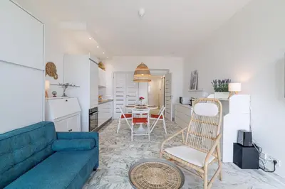 a living room with a blue couch and a table at Sea View & Terrace Promenade des Anglais in Nice