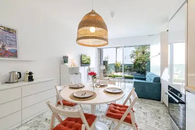 a kitchen and dining room with a table and chairs at Sea View & Terrace Promenade des Anglais in Nice