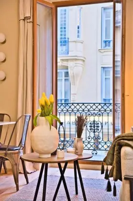 a living room with a table with a vase on it at MAYERBEER - Apartment 2 bedrooms with balcony in Nice
