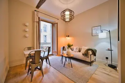 a living room with a couch and a table at MAYERBEER - Apartment 2 bedrooms with balcony in Nice