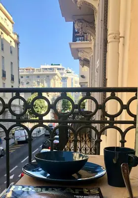 a table with two bowls on top of a balcony at MAYERBEER - Apartment 2 bedrooms with balcony in Nice