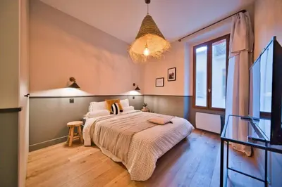 a bedroom with a large bed and a large window at MAYERBEER - Apartment 2 bedrooms with balcony in Nice