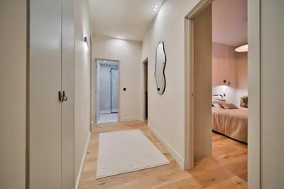 a hallway with a white rug and a bedroom at MAYERBEER - Apartment 2 bedrooms with balcony in Nice