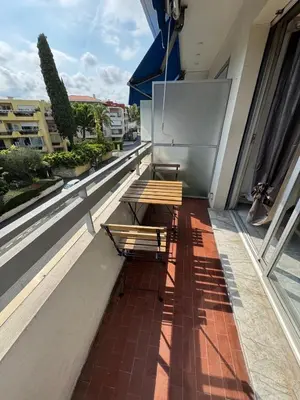 two benches sitting on the balcony of a building at Apartment in Cros de Cagnes in Cagnes-sur-Mer