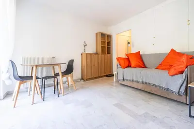 a living room with a bed and a table and chairs at L'Échappée Belle in Nice