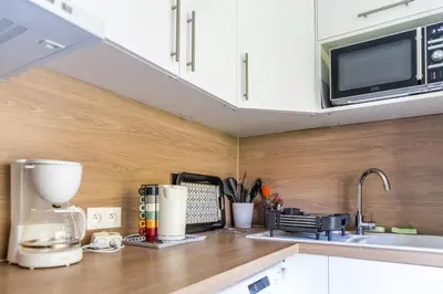 a kitchen with a counter top with a coffee maker and a microwave at L'Échappée Belle in Nice