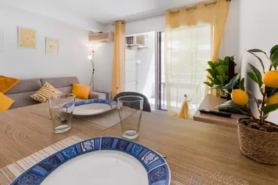 a living room with a table with a blue plate on it at Le Seaside - Beach - Tram - Airport - AC in Nice