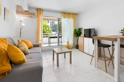 a living room with a couch and a table at Le Seaside - Beach - Tram - Airport - AC in Nice