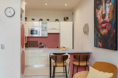 a kitchen with a counter and two bar stools at #3 Mascoinat 1BDR Old Town, near beach Fan & WIFI in Nice