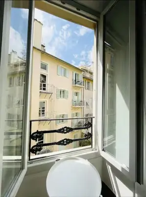 a toilet in a room with a large window at Studio en plein centre de Nice, proche Tramway in Nice