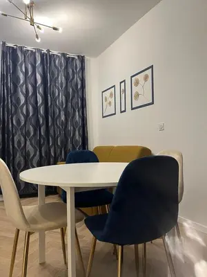 a dining room with a white table and chairs at MOON - 31 in Nice