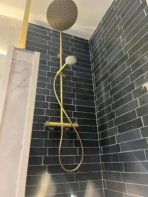 a shower in a bathroom with a blue tiled wall at MOON - 31 in Nice