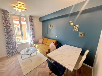 a living room with a couch and a table at MOON - 37 in Nice