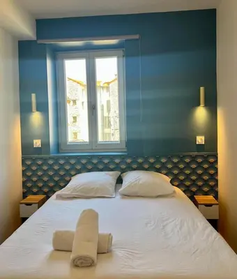 a bedroom with a large bed with two towels on it at MOON - 37 in Nice