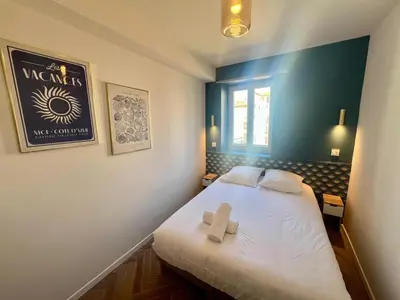 a small room with a bed with a cross on it at MOON - 37 in Nice