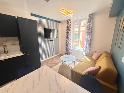 a living room with a couch and a table at MOON - 37 in Nice