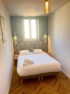 a bedroom with a large bed with a window at MOON - 37 in Nice