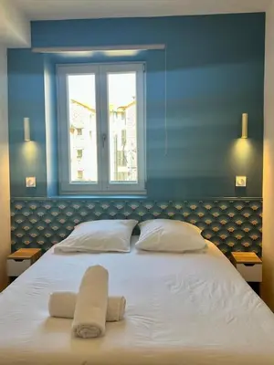 a large bed with two towels on top of it at MOON - 37 in Nice