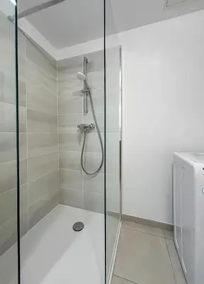 a shower with a glass door in a bathroom at Spacieux T2 à 150m Des Plages in Cagnes-sur-Mer