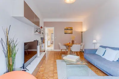 a living room with a blue couch and a table at LE LAFAYETTE 2 AP4474 by Riviera Holiday Homes in Nice