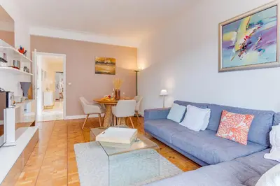 a living room with a blue couch and a table at LE LAFAYETTE 2 AP4474 by Riviera Holiday Homes in Nice