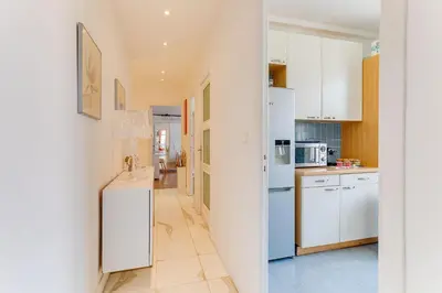 a kitchen with white cabinets and white appliances at LE LAFAYETTE 2 AP4474 by Riviera Holiday Homes in Nice