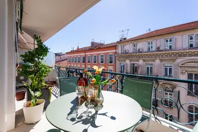 a table on a balcony with a view of buildings at LE LAFAYETTE AP4410 By Riviera Holiday Homes in Nice