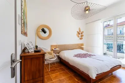 a bedroom with a bed and a desk and a window at LE LAFAYETTE AP4410 By Riviera Holiday Homes in Nice