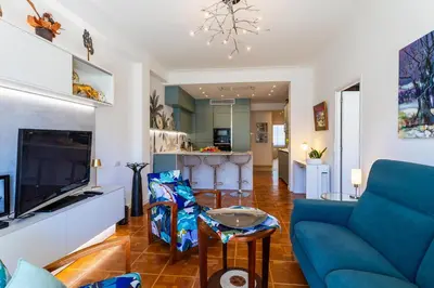a living room with a blue couch and a tv at LE LAFAYETTE AP4410 By Riviera Holiday Homes in Nice
