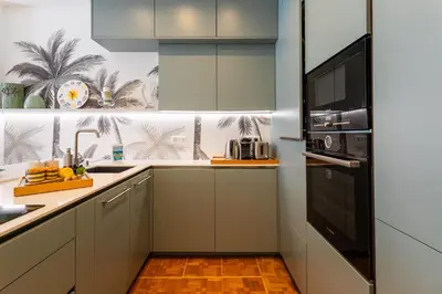 a kitchen with white cabinets and a black microwave at LE LAFAYETTE AP4410 By Riviera Holiday Homes in Nice