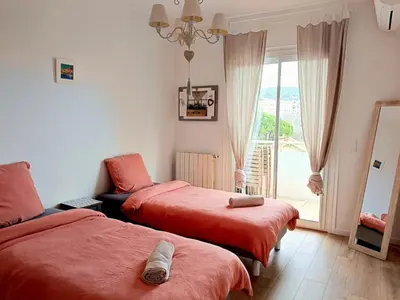 a bedroom with two beds and a window at Stunning 2 bedroom apartment with Terrace and Sea view, Nice Cimiez Liberation in Nice