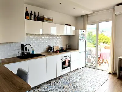 a kitchen with white cabinets and a refrigerator at Stunning 2 bedroom apartment with Terrace and Sea view, Nice Cimiez Liberation in Nice