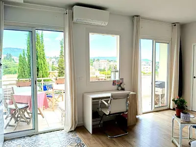 a living room with a fireplace and large windows at Stunning 2 bedroom apartment with Terrace and Sea view, Nice Cimiez Liberation in Nice