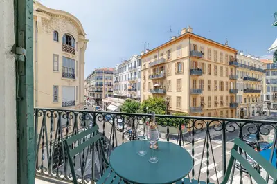 a table with a wine glass on a balcony at T2 situé au centre-ville de Nice in Nice