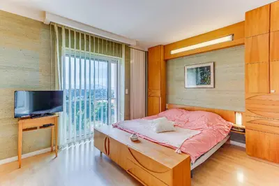 a bedroom with a bed and a tv and a window at VILLA DYONIS VI4439 by Riviera Holiday Homes in Nice