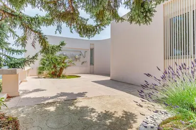 a courtyard of a house with trees and plants at VILLA DYONIS VI4439 by Riviera Holiday Homes in Nice