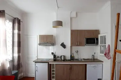 a white bathroom with a shower and a sink at charmant studio sur le port de Nice in Nice