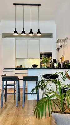a kitchen with blue tables and white cabinets at Bel appartement 2 pièces à Nice in Nice