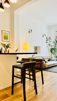 a living room with a table and a couch at Bel appartement 2 pièces à Nice in Nice