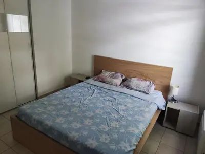 a bedroom with a bed with two pillows on it at Appartement deux pièces bien situé et pratique in Nice
