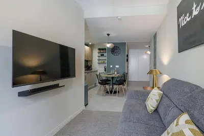 a living room with a couch and a tv on a wall at Appartement confort centre ville de Nice in Nice