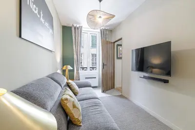 a living room with a couch and a flat screen tv at Appartement confort centre ville de Nice in Nice