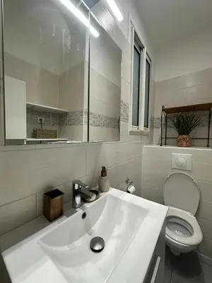 a white bathroom with a sink and a toilet at Nice Jussieu 2 pièces entièrement rénové in Nice