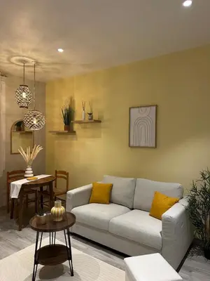 a living room with a couch and a table at Nice Jussieu 2 pièces entièrement rénové in Nice