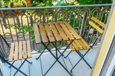 a wooden bench sitting next to a fence at Central- walk to Massena & Beach in Nice