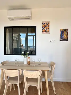 a dining room with a table and chairs and a window at TheNiceTerrace in Nice